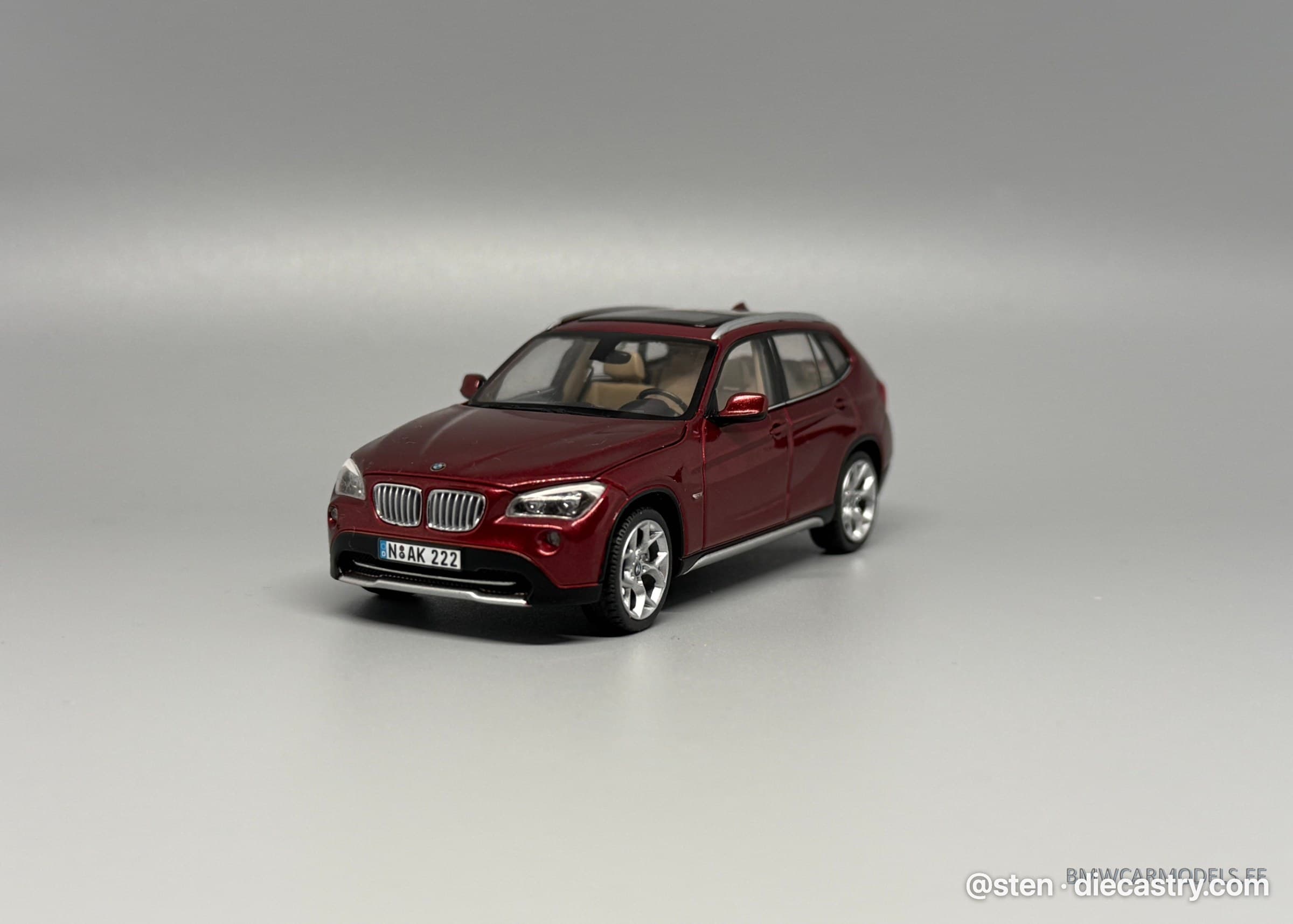BMW X1 (E84) 1:43 scale diecast model by Schuco in Vermillionrot