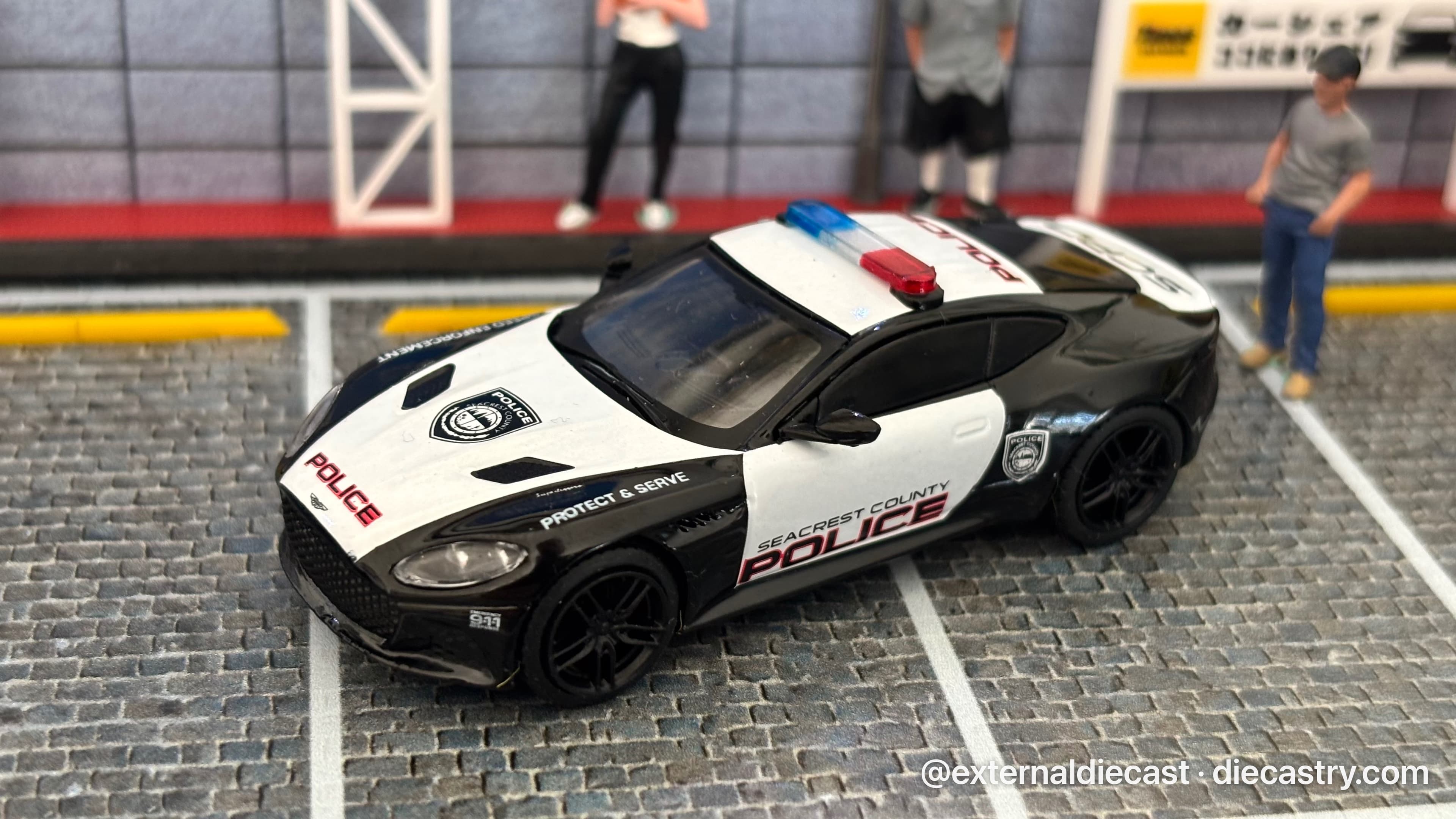 2018 Aston Martin DBS Superleggera Police 1:64 scale diecast model by Tarmac Works in White & Black